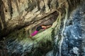 Woman practice yoga in small cave on trip to mountain