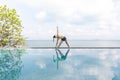 Woman practice yoga Triangle pose to meditation summer vacation on the pool above the beach,Travel in tropical beach