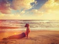 Woman practices yoga asana Urdhva Mukha Svanasana at the beach Royalty Free Stock Photo