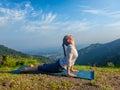 Woman practices yoga asana Urdhva Mukha Svanasana outdoors Royalty Free Stock Photo