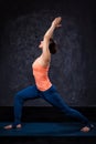 Woman practices yoga asana utthita Virabhadras Royalty Free Stock Photo