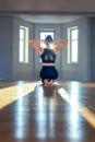 A woman practices yoga in a fitness room at dawn. Concentration, beautiful sunshine, stretching, healthy lifestyle.