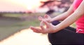 Woman practices yoga and meditates on the nature sunset background Royalty Free Stock Photo