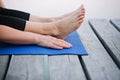 Woman practices yoga outdoors near a river on a wooden pier in the morning. Healthy lifestyle concept. Morning meditation,