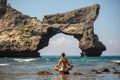 Woman practices yoga at seashore