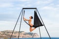 Woman practicing fly dance gravity yoga poses in a hammock outdoors Royalty Free Stock Photo