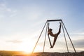 Woman practicing fly dance yoga poses in hammock outdoors at sunset Royalty Free Stock Photo