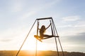 Woman practicing fly dance yoga poses in hammock outdoors at sunset Royalty Free Stock Photo