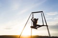 Woman practicing fly dance yoga poses in hammock outdoors at sunset Royalty Free Stock Photo