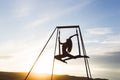 Woman practicing fly dance yoga poses in hammock outdoors at sunset Royalty Free Stock Photo