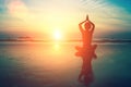 Woman practicing meditation near the ocean.