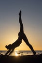 woman practicing stretching at sunset. seaside background, silhouette Royalty Free Stock Photo