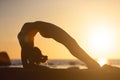 woman practicing stretching at sunset. seaside background, silhouette Royalty Free Stock Photo
