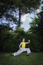 Woman practicing Tai Chi Quan in the park. Tai Chi is a physical and mental practice originating in China that combines smooth,