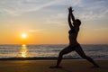 Woman practicing Yoga on the beach Royalty Free Stock Photo