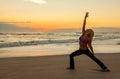 Woman Practicing Yoga on Beach At Sunrise or Sunset Royalty Free Stock Photo