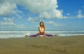 Young happy and attractive girl doing flexibility exercise with legs split  on sand in wellness harmony health care and fitness Royalty Free Stock Photo