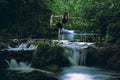 Woman practicing yoga at cascade