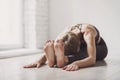 Woman practicing yoga in class, young woman doing exercises at home.