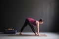 Woman practicing yoga, doing Half Pyramid or Parshvottanasana