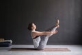 Woman practicing yoga, doing Paripurna Navasana exercise, balance pose Royalty Free Stock Photo