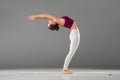 woman practicing yoga, doing Standing Backward Bend exercise, Ardha