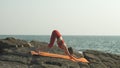 woman practicing yoga in a downward facing dog pose Royalty Free Stock Photo