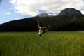 Woman practicing yoga in the grass