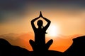 Woman practicing yoga lotus pose on mountain with sunset, calm environnement for breathing, concentrate and recovering energy Royalty Free Stock Photo