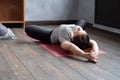 Woman practicing yoga in Reclined Butterfly exercise, supta baddha konasana Royalty Free Stock Photo