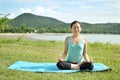 Woman is practicing yoga at mountain lake Royalty Free Stock Photo