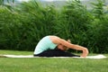 Woman practicing yoga in the park Royalty Free Stock Photo