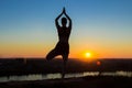 Woman practicing yoga in the park at sunset Royalty Free Stock Photo