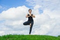 Woman practicing yoga relax in nature and blue sky background