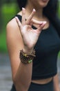 Woman practicing yoga showing jnana mudra sign, stress free meditation practice, exercising in the park