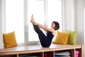 Woman practicing yoga, sitting in Boat pose exercise, Paripurna Navasana, workout, wearing black sportswear, full length Royalty Free Stock Photo