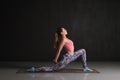 Woman practicing yoga, standing in anjaneyasana pose, doing Horse rider exercise Royalty Free Stock Photo