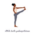 Woman practicing yoga, standing in Extended Hand to Big Toe exercise, Utthita Hasta Padangustasana pose