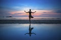 Woman practicing yoga during sunset at seaside. Royalty Free Stock Photo