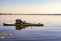 Woman is practicing yoga on a SUP board Royalty Free Stock Photo