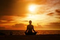 woman practicing yoga during surrealistic sunset at the seaside. Royalty Free Stock Photo