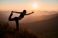 Woman is practicing yoga in Swallow pose in mountains. Royalty Free Stock Photo