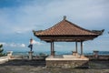 Woman practicing yoga in traditional balinesse gazebo