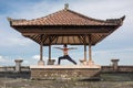 Woman practicing yoga in the traditional balinesse gazebo