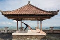 Woman practicing yoga in the traditional balinesse gazebo