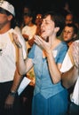 A woman praises God during a religious retreat