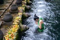 Woman pray and bath holy spring waters in Tirta Empul water temple, Bali, Indonesia. Royalty Free Stock Photo