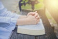 Woman pray with bible in the garden. Royalty Free Stock Photo