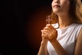 Woman pray to God with Cross on black background; Woman Pray for god blessing