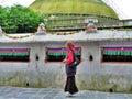 Woman with prayer beads circumnavigating the stupa, Boudhanath, Nepal